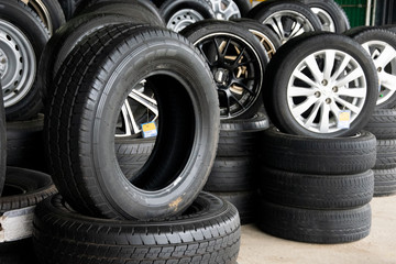 Set of new modern tires in shop. Sale a tire in shop in the background.