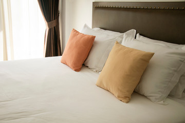 white and color pillow in bedroom