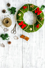 Christmas decoration concept. Traditional green christmas wreath near matherials and instruments,...