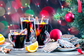Mulled wine and cookie on wooden table.