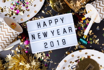 Happy new year 2019 on light box with party cup,party blower,tinsel,confetti.Fun Celebrate holiday...