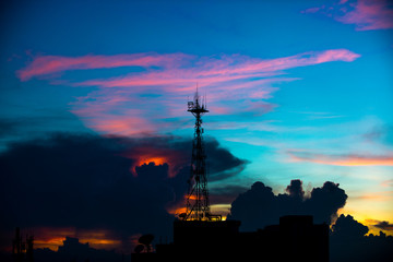 Silhouette of cellular tower with Civil twilight Sky and Clouds