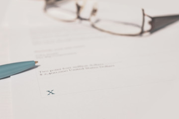 Hand signing legal contract for gaining ownership of company.  Binding legal contract.