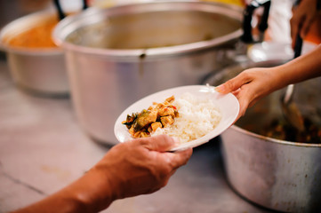 The hands of the poor receive food from the hands of the philanthropist : concept of giving