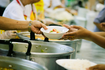 The hands of the poor receive food from the hands of the philanthropist : concept of giving