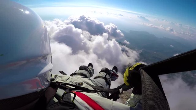 Man flying on paraplane in sky, clouds and skyline landscape. Point of view paraglider flying on paraplane. Active sport and extreme hobby.