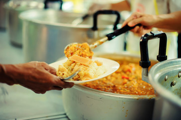The hands of the poor receive food from the hands of the philanthropist : concept of giving