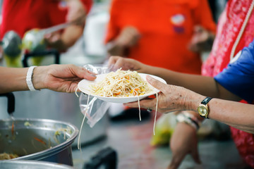 The hands of the poor receive food from the hands of the philanthropist : concept of giving