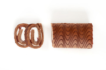 Chocolate biscuit roll cake isolated on white background.