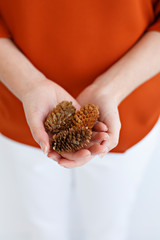 women holding mini pinecones