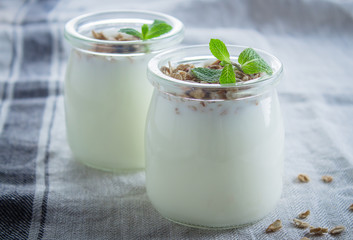 Obraz na płótnie Canvas Homemade granola with greak yogurt in a glass jar. Healthy food concept. CLose-up