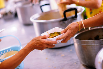 Volunteers provide food for beggars: Concepts Feeding and help