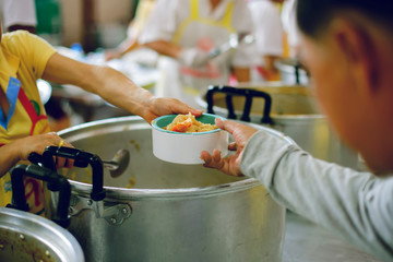 Volunteers provide food for beggars: Concepts Feeding and help