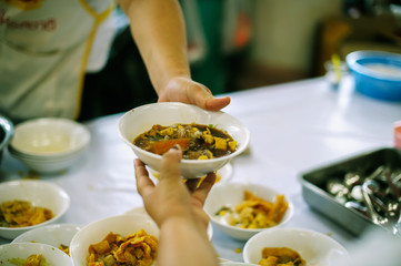 Volunteers provide food for beggars: Concepts Feeding and help