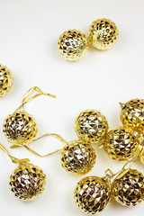 Several golden christmas balls on white background