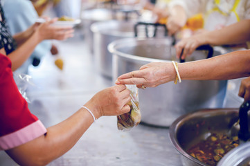 Volunteers provide food for beggars: Concepts Feeding and help