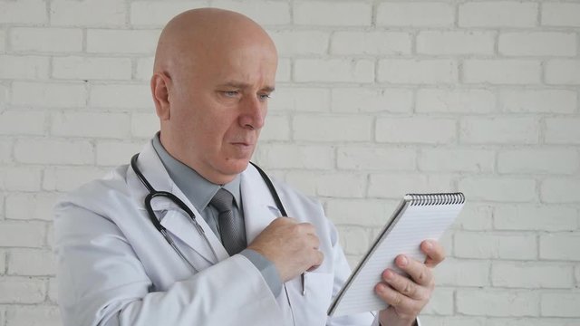 Slow Motion with a Confident Doctor Writing a Medical Recipe in Hospital 