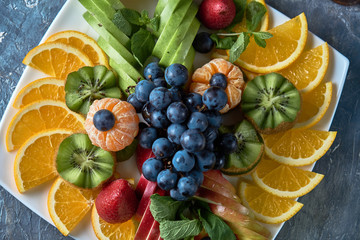 fruit plate. Glass bank of lemonade with sliced citrus fruits on a buffet table