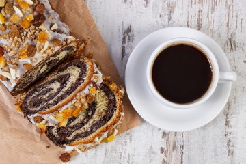 Portion of poppy seeds cake and cup of coffee, dessert for Christmas time
