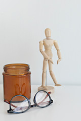 desktop with wooden figure and jar
