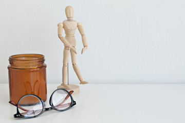 white desktop with wooden doll