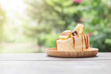 The cake on the table with green garden background