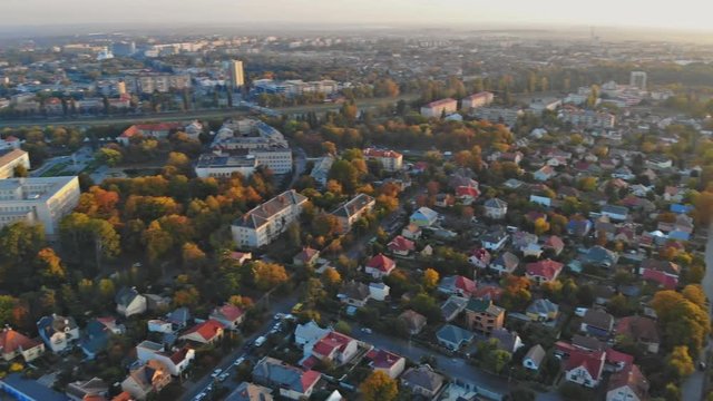 View from the height of the city on the roofs of houses, trees, mountains in the Cloudy sky. Cloudy sky.