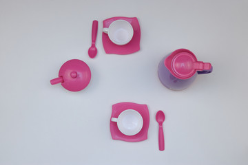 children's toy dishes for tea on a white background