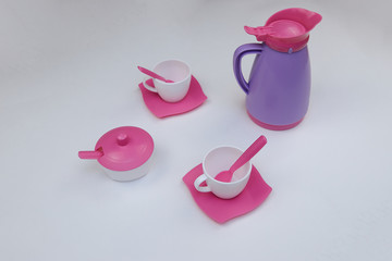 children's toy dishes for tea on a white background