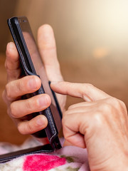 A woman holds a mobile phone in her hands. Work in the office_