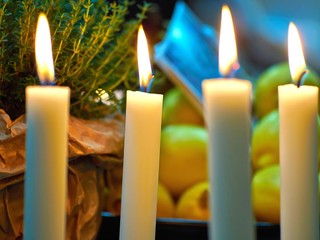 Candles light on a dining table
