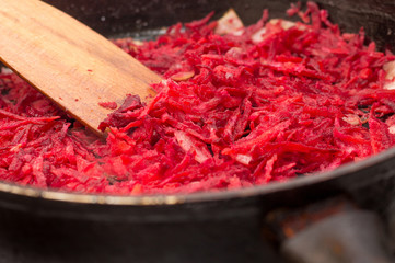 Cook of red beet dishes in a frying pan. Useful natural food_