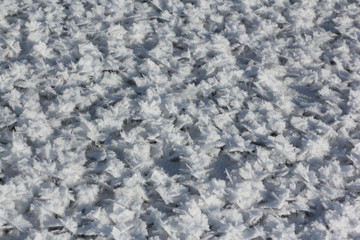 Snow frost on the ice on the river, natural background