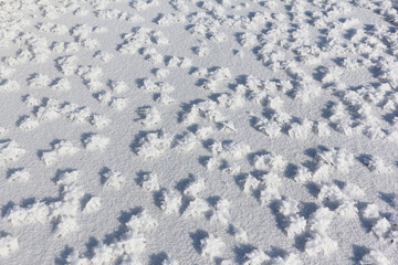 Snow frost on the ice on the river, natural background