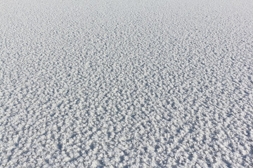 Snow frost on the ice on the river, natural background