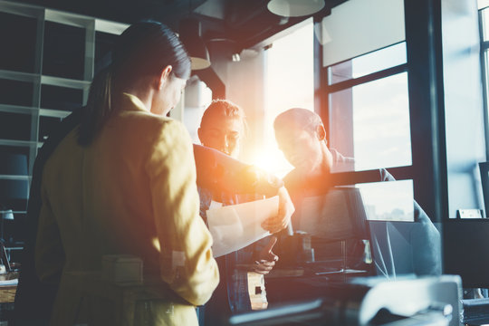 Business office concept. Four managers discuss work plans and strategy in the meeting room