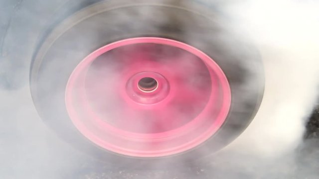 Drag car make tires warm up with smoke, Car racing burnout rubber off its tires in preparation for the race.