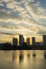 Naklejka premium the sun sets in the buildings across the Tama River Kawasaki Kanagawa Japan