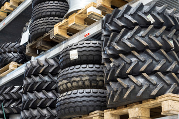 Industrial warehouse of spare parts. On the shelves are many tires