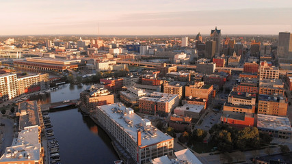 Fototapeta na wymiar Milwaukee river in downtown, harbor districts of Milwaukee, Wisconsin, United States. Real estate, condos in downtown. Aerial view, drone flying