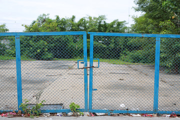 Fototapeta premium chain link fence and metal door with lock