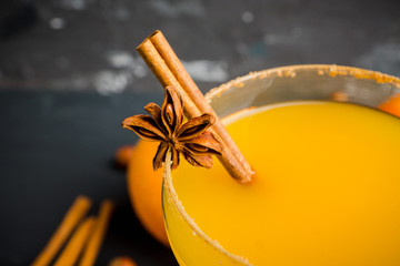 Tasty pumpkin margarita cocktail on the rustic background. Selective focus. Shallow depth of field.