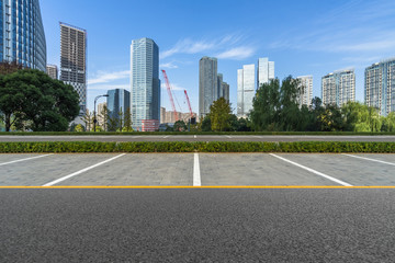 Fototapeta na wymiar empty car park with downtown city space background