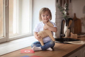 baby with Down syndrome learns and plays © natalialeb