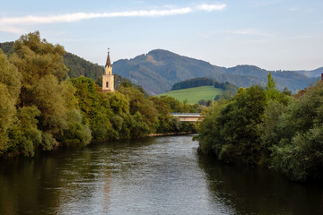 Fototapeta na wymiar View of Mur river with church in Leoben,Austria