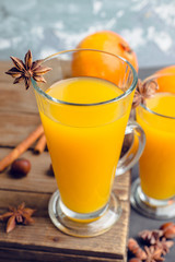 Hot pumpkin drink in glass on the rustic background. Selective focus. Shallow depth of field.