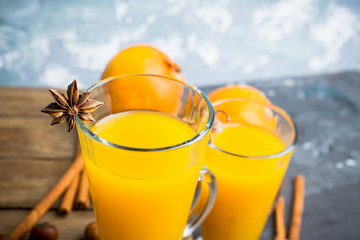 Hot pumpkin drink in glass on the rustic background. Selective focus. Shallow depth of field.