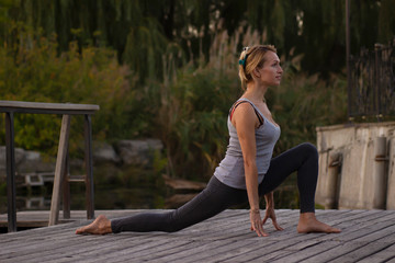 Young happy mother  practicing yoga