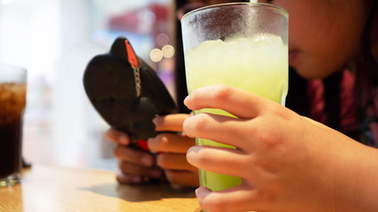 Children play phone on dining table, Concept kids are social network at all times.