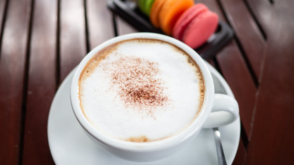 Coffee with Cookies Macaroon Placed together on a wooden table.
